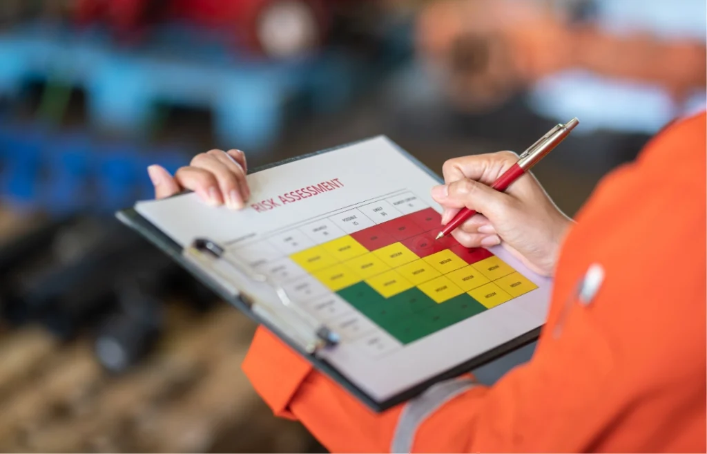 manager-is-using-ballpoint-pen-marking-risk-assessment-matrix-high-risk-level